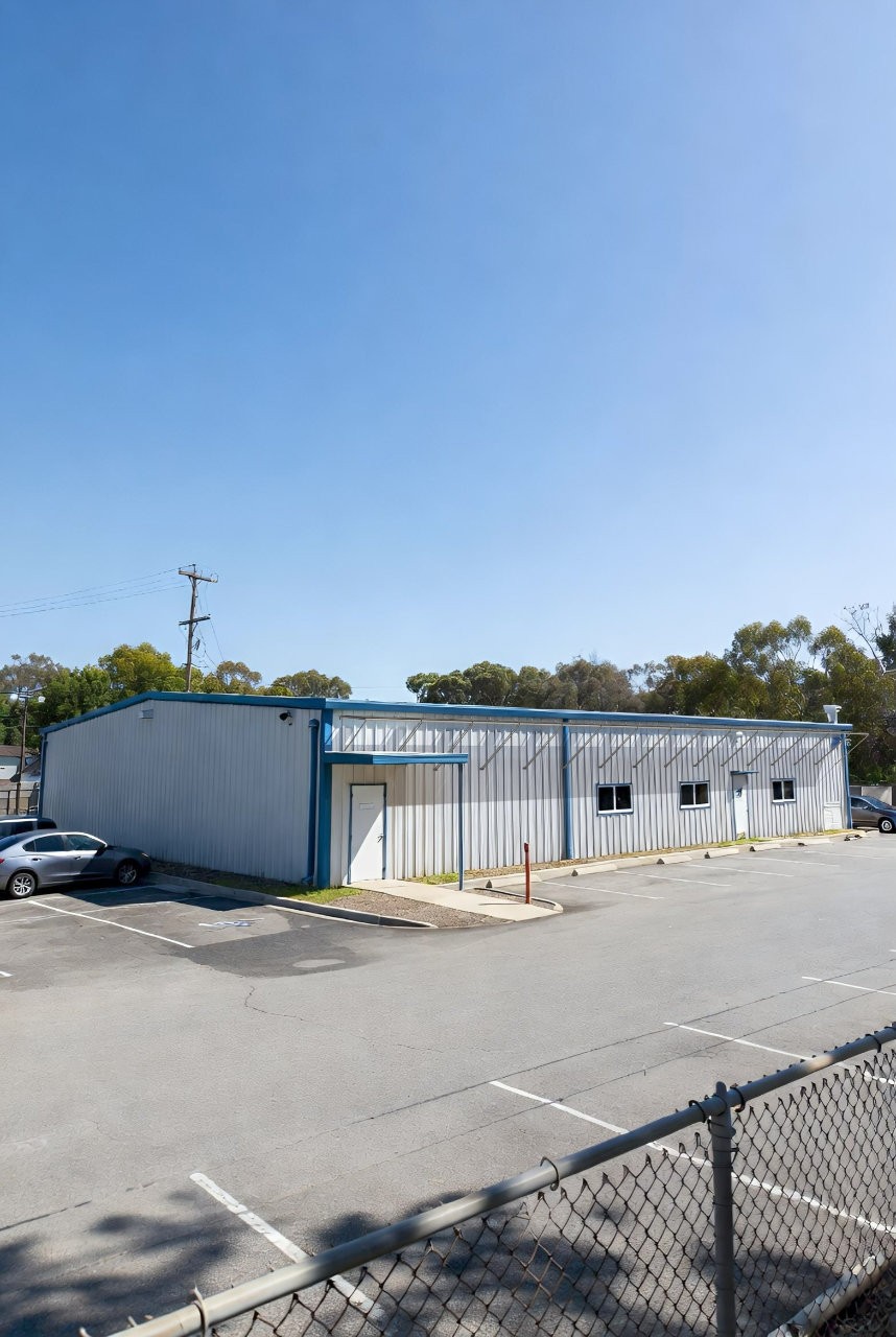 A warehouse with panels adhered near the roof line.