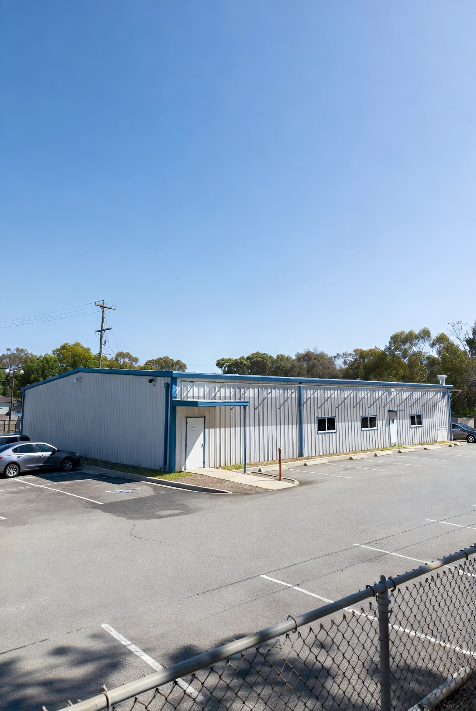 A warehouse with panels adhered near the roof line.